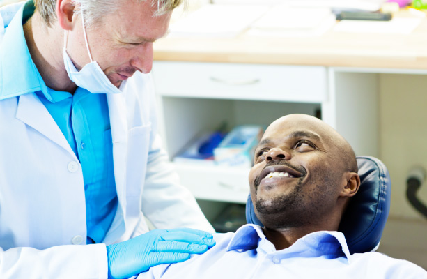 african american man in dental chair asking how sedation can help with dental anxiety