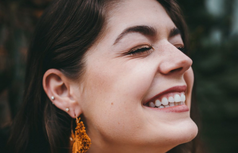 girl smiling with a big white toothy smile from dental sealants