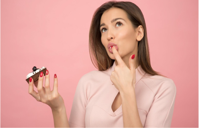 woman eating a sweet treat during the holidays