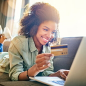 woman with credit card looking at computer