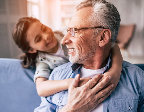 Grandfather and granddaughter looking at each other