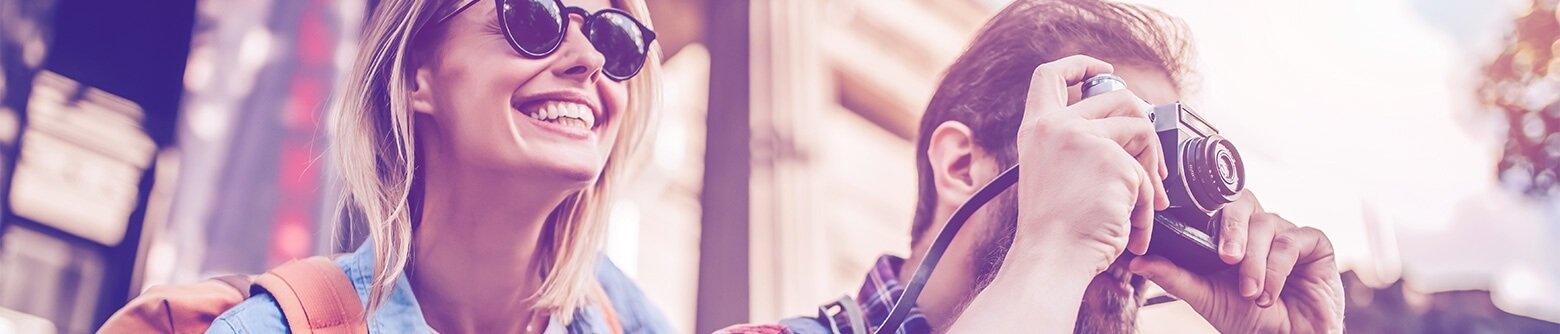 Man taking photo while woman smiles