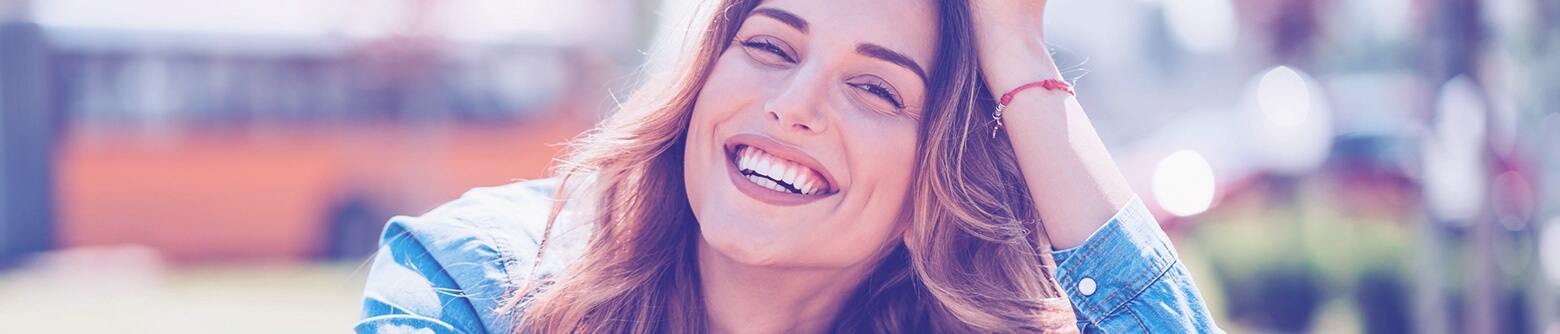 Woman smiling in denim jacket