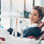 Brunette woman in a dental chair smiles before receiving root canal treatment in Canton, GA