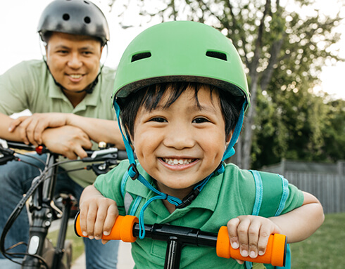 child and his dad on a bike