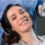 young woman gets a dental exam and cleaning