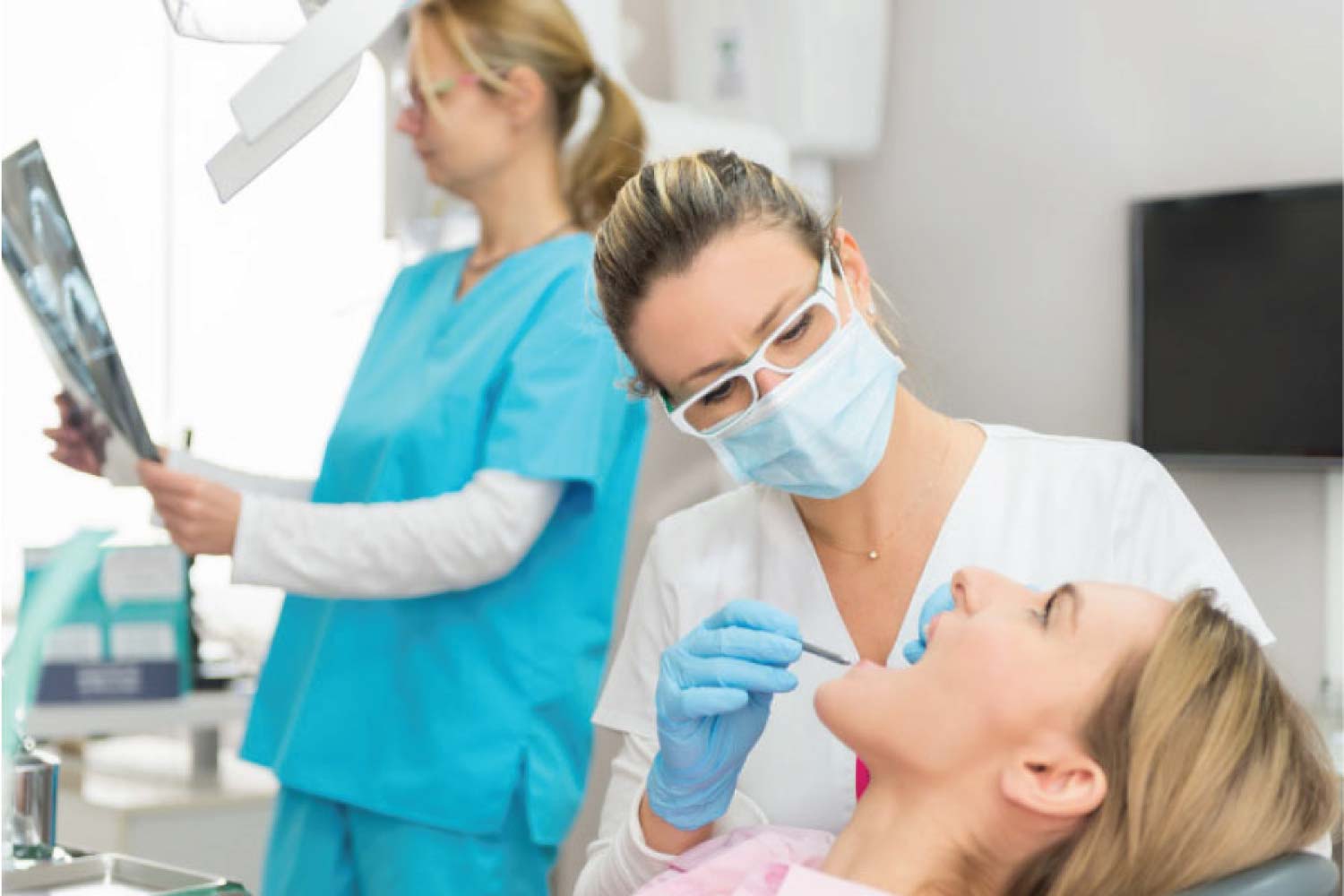 female dental patient getting a routine dental exam