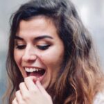 woman checks her tooth enamel