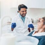 young woman in the dentist chair gets a routine exam and cleaning