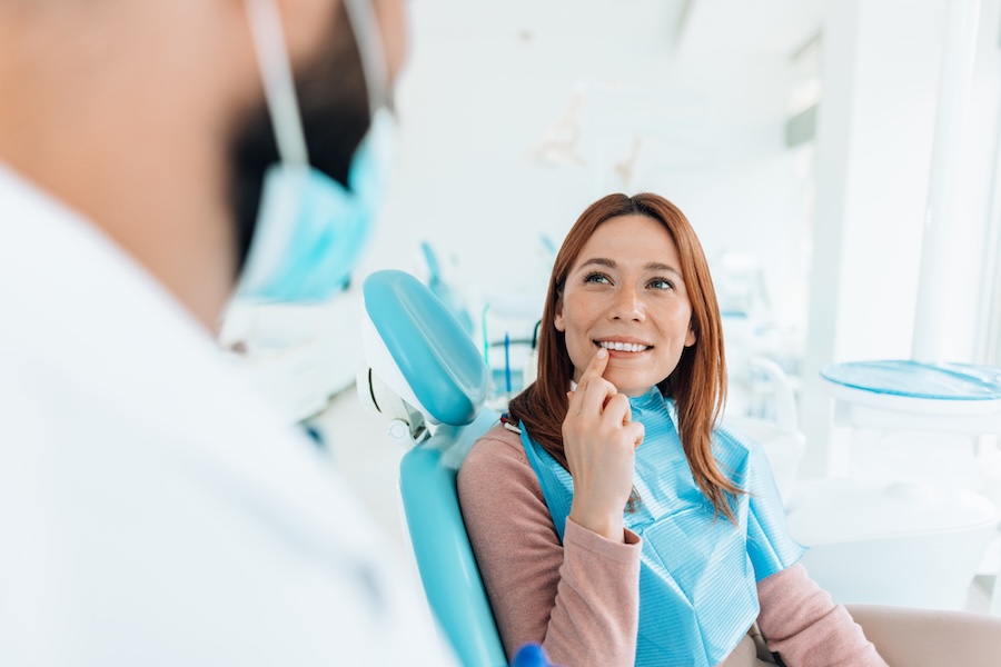woman discussing gum contouring with her dentist
