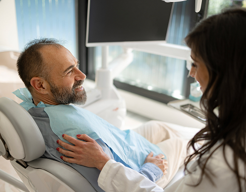 man talking to dentist